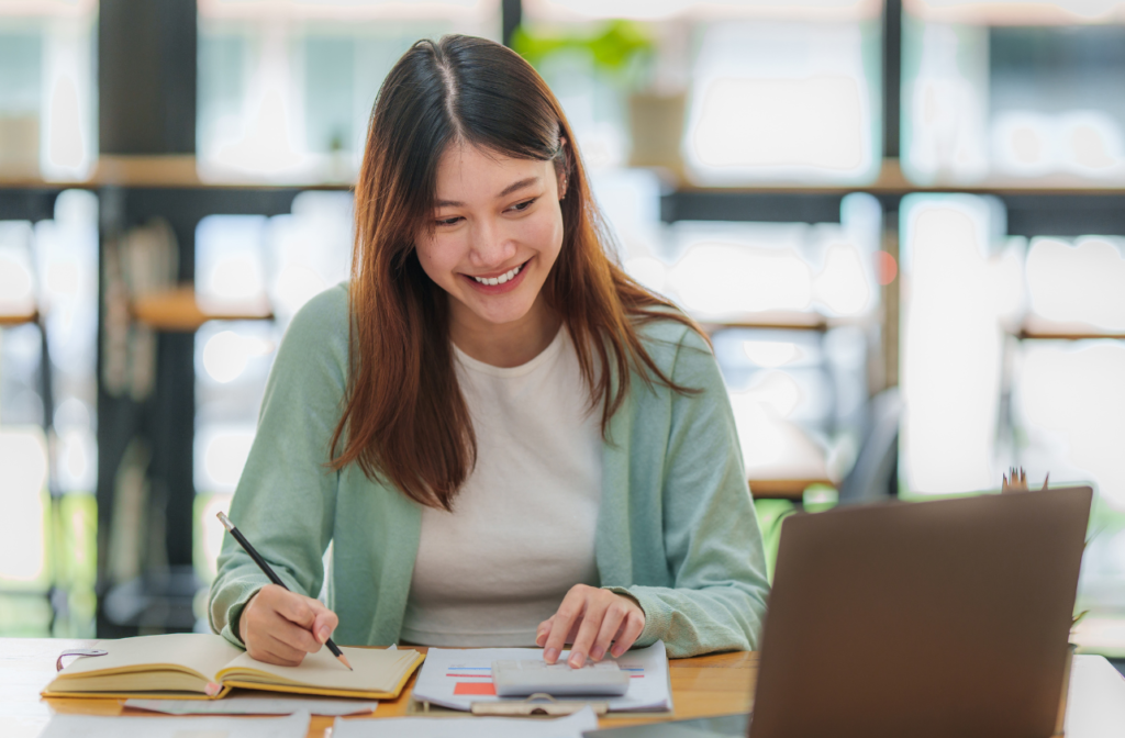 Woman smiling as she does work.