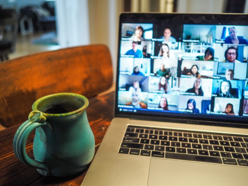 An image of a Zoom meeting with a coffee mug.