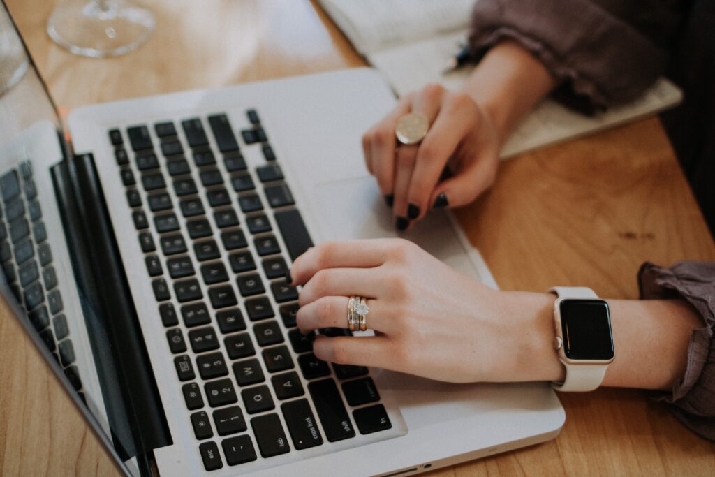 image of a woman hands on a laptop.