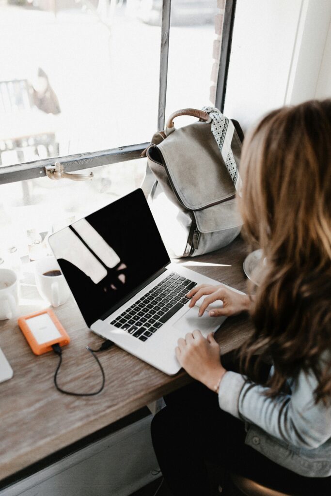 Woman writing on her laptop.