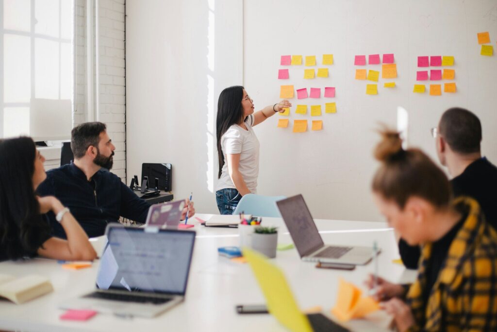 Image of a woman leading a team through a presentation.