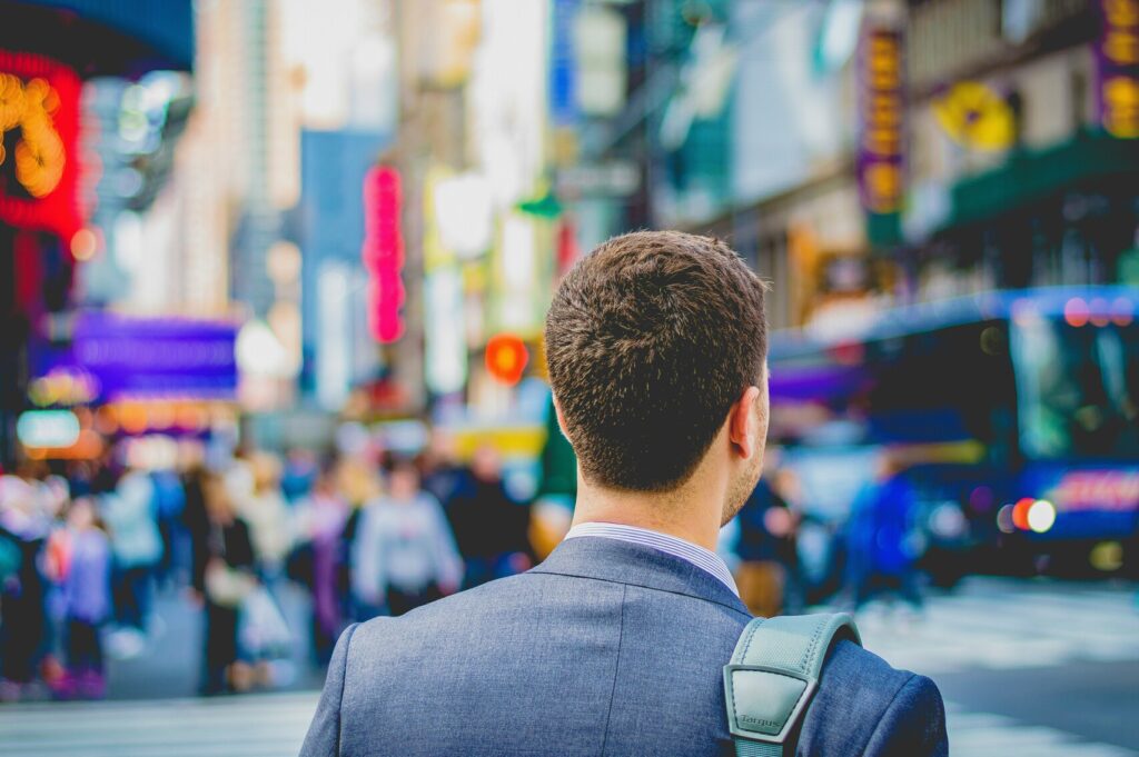 Image of an individual in a suit at Time Square.