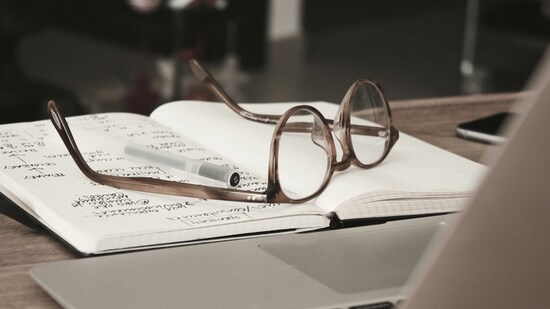 Image of glasses on top of a notebook.