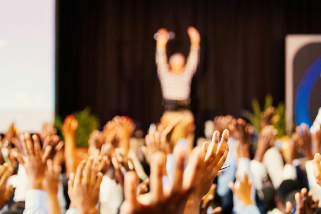 A blurry image of individuals in a networking event.