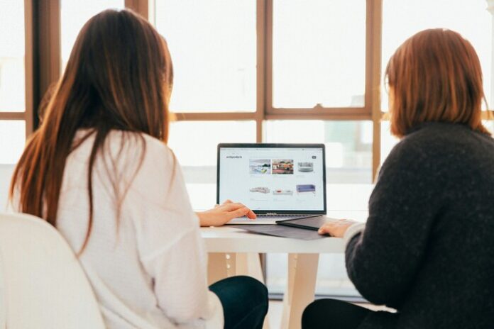 image of 2 women to indicate one is advising the other.