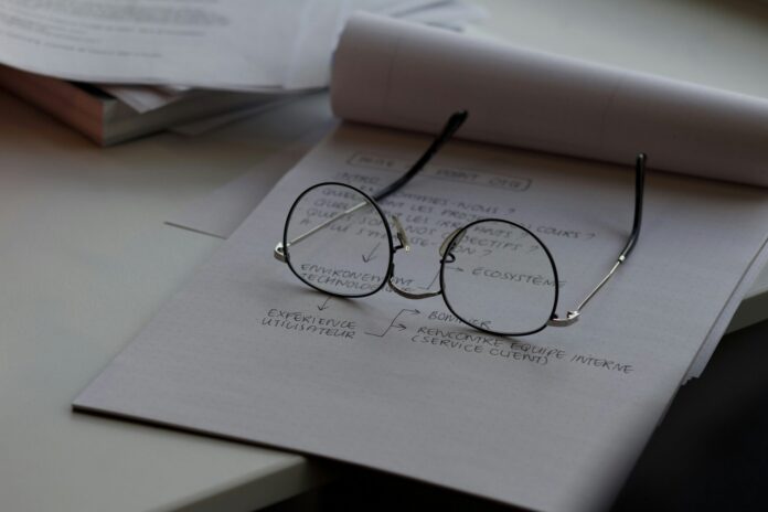 Image of glasses on a notepad.